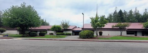 Discovery Elementary, a single story school building, sits among the trees.